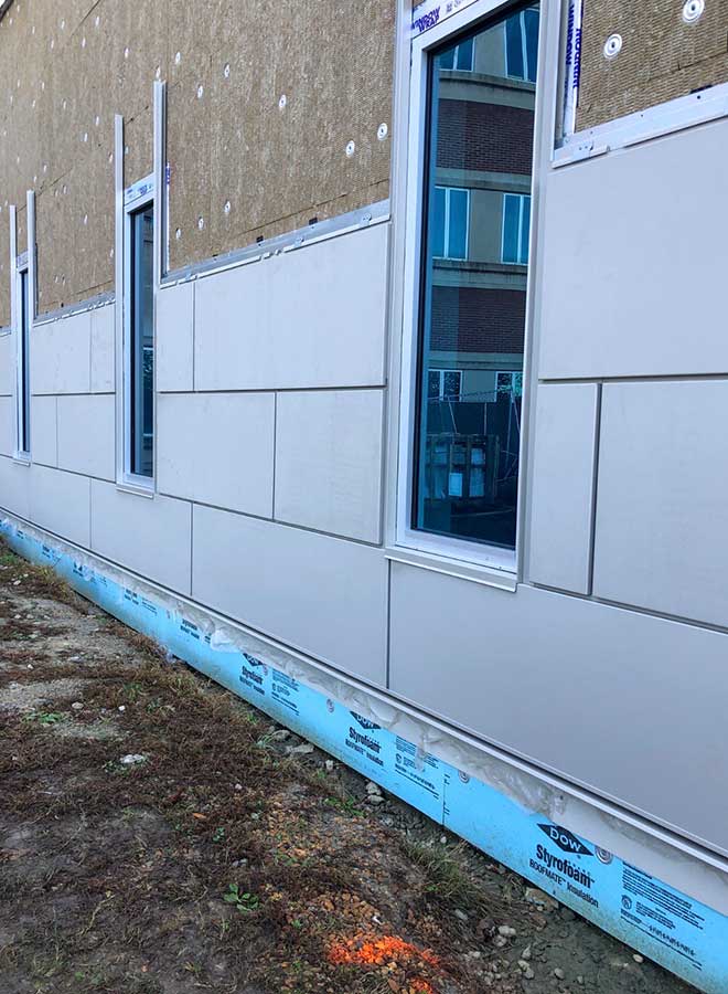 Steel stud wall section showing continuous insulation maintaining sheathing temperature above dew point.